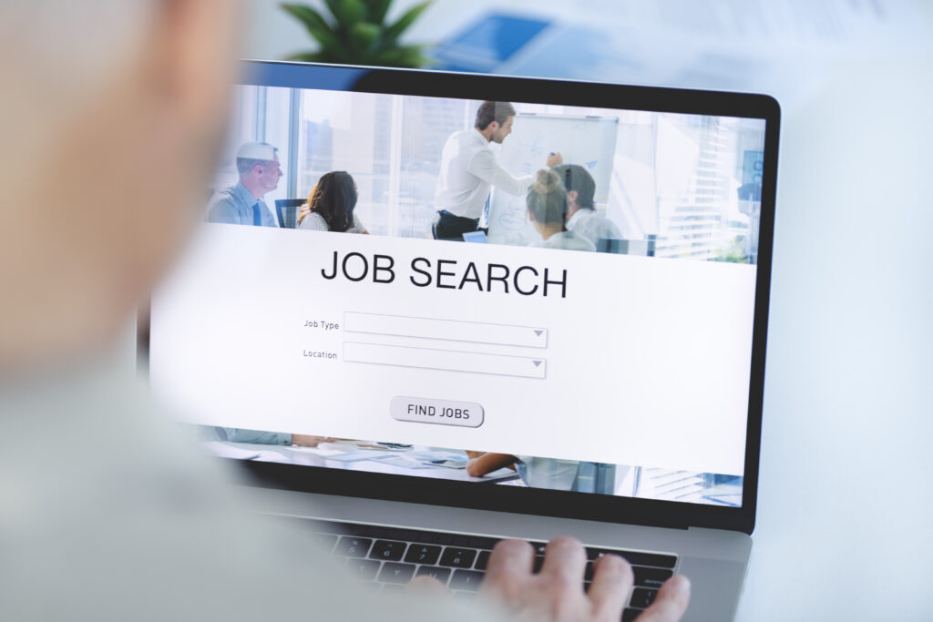 Mature Businessman looking at job search website on a laptop computer.